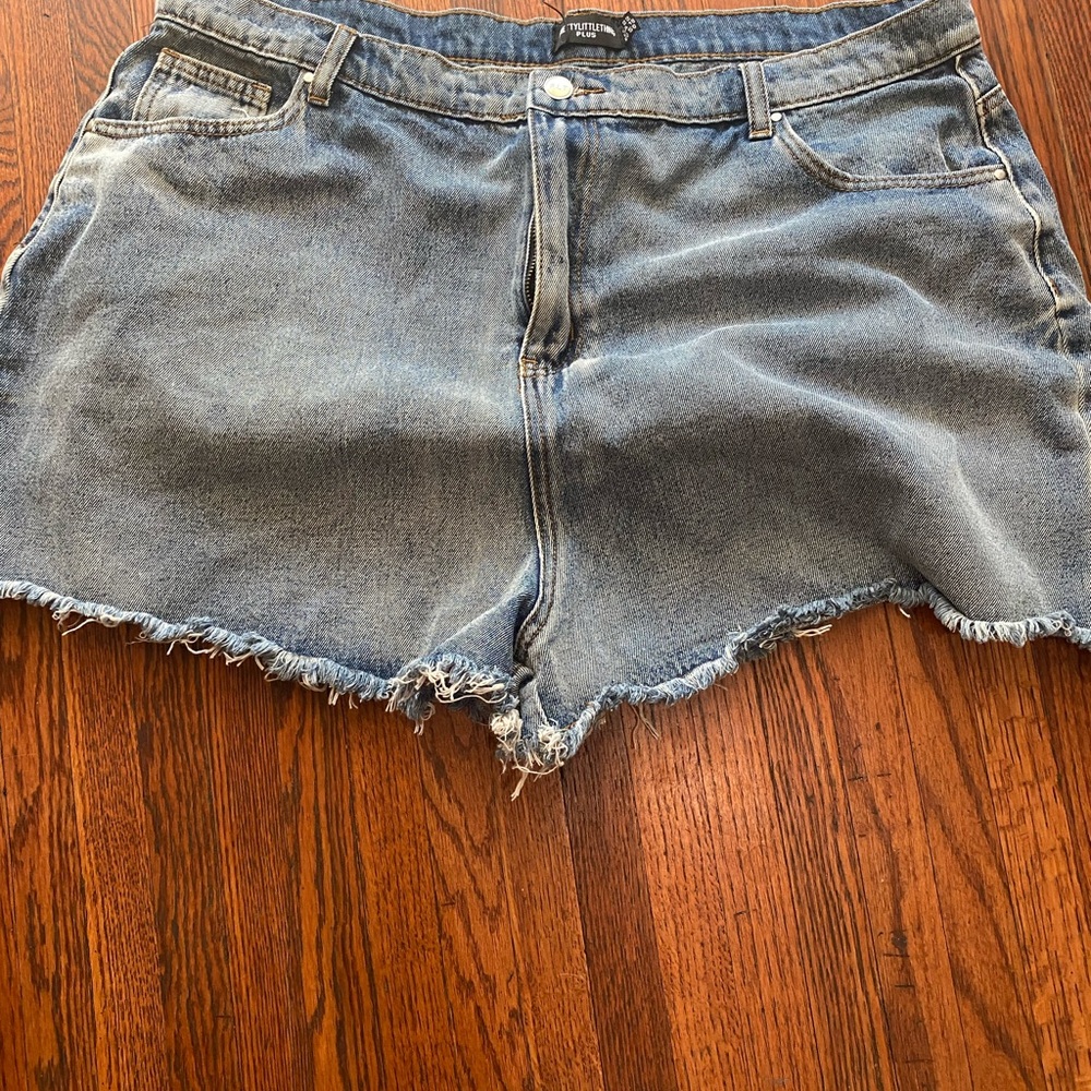 Plus size jean shorts with fringe bottom